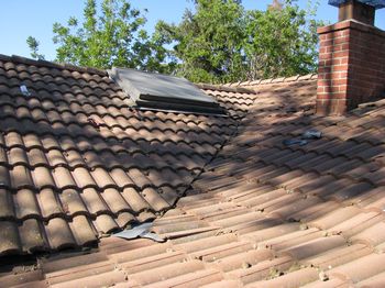 curved tiles are hiding dirt and debri in this roof valley